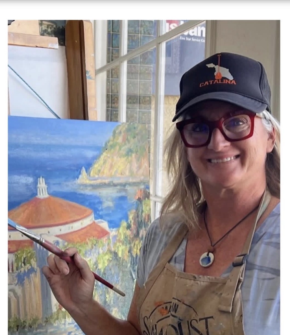 Kymberlee Stanley painting in her studio